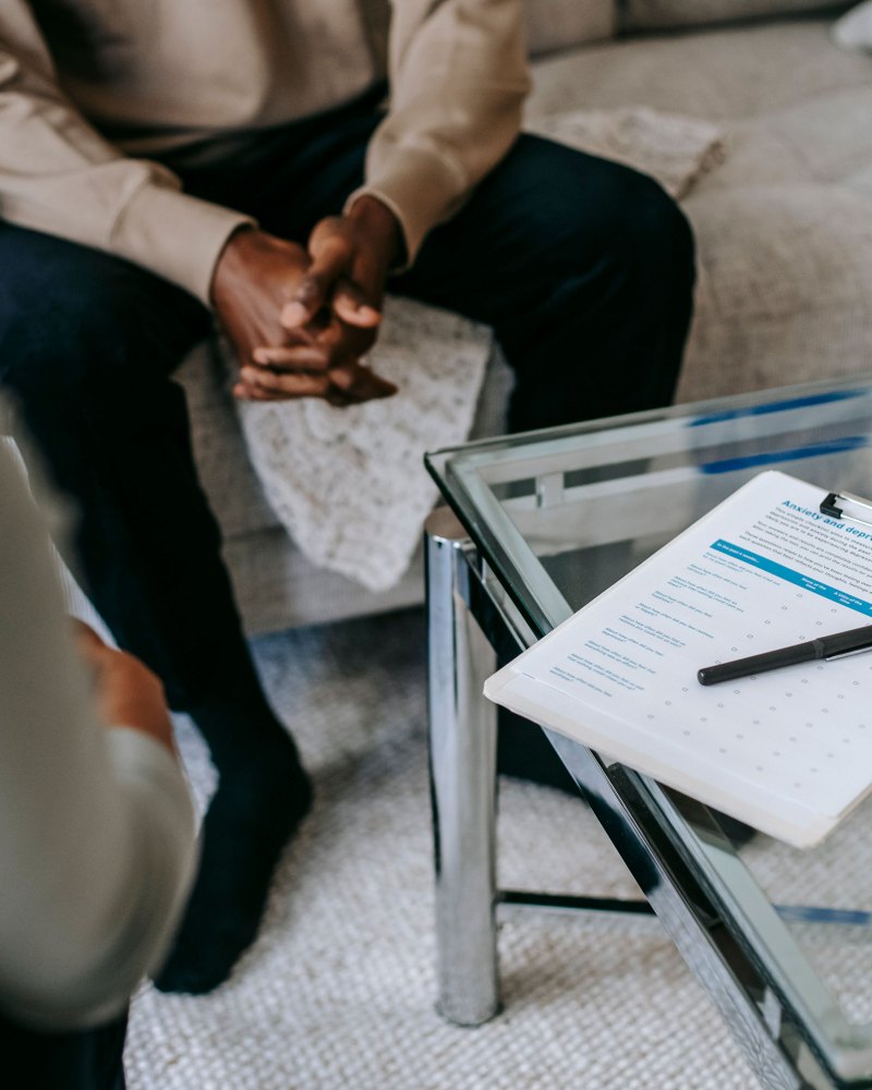 A therapist and client during a calm session, with an anxiety and depression checklist